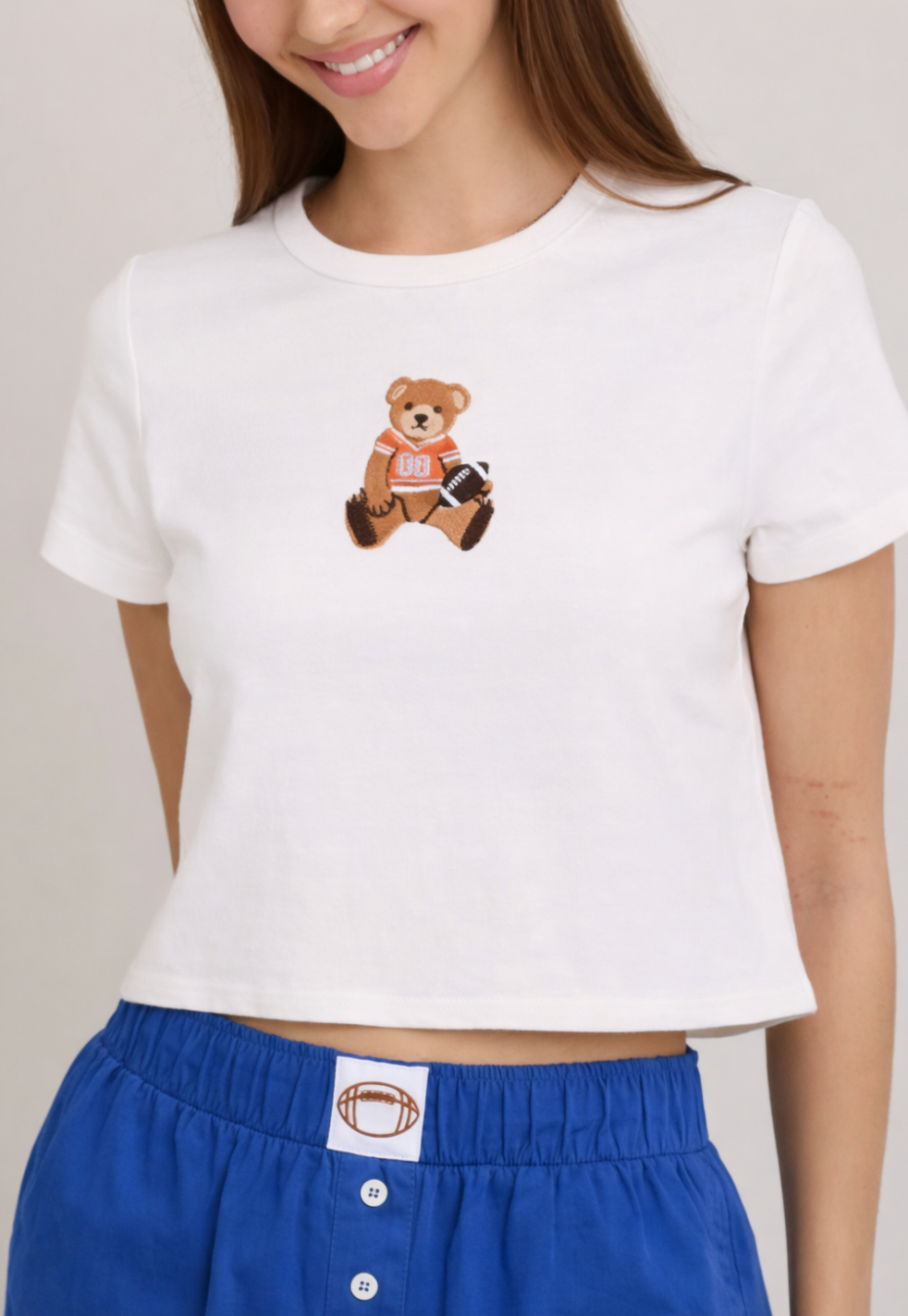 Football Star Teddy Bear Baby Tee in White & Orange – Sixteen